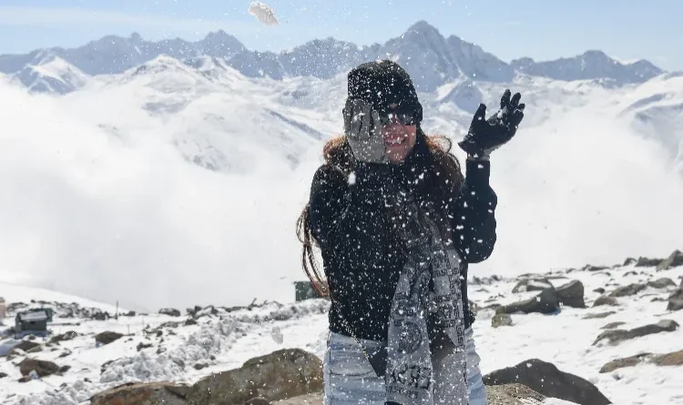A white blanket of snow covers the Apharwat peak in Gulmarg, bringing smiles to the faces of tourists.